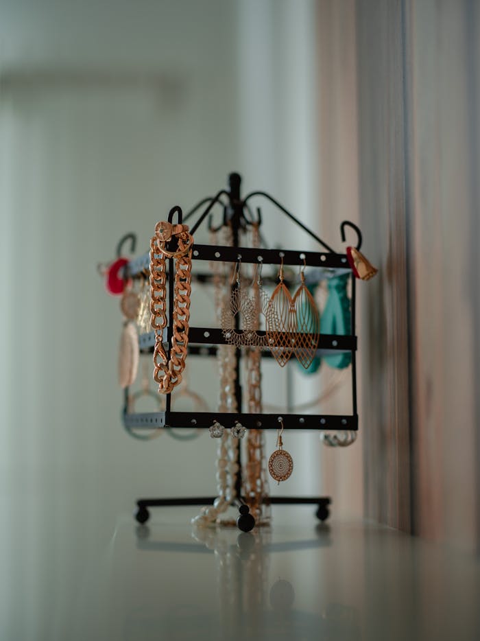 Close-up of various jewelry pieces on a metal stand, highlighting elegance and style.